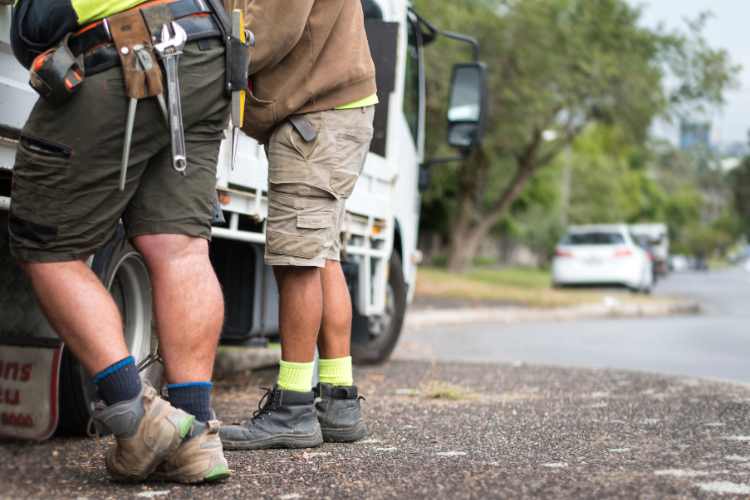 Tradies standing next to a truck